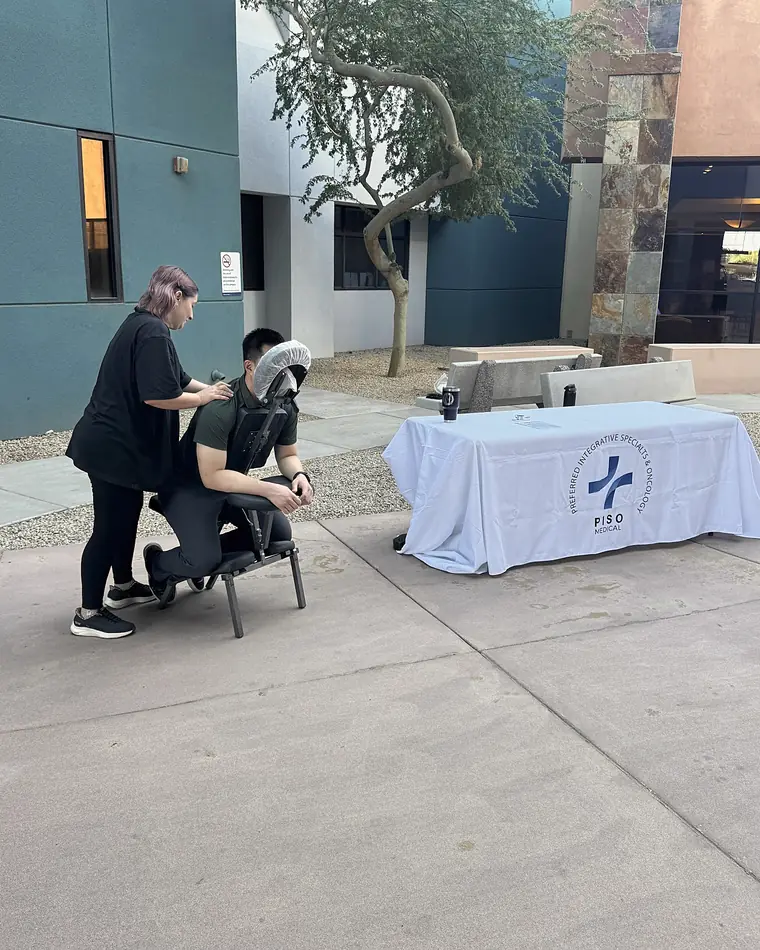 A PISO team member giving a chair massage at a community event
